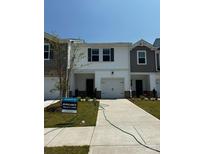 Charming new construction townhome featuring a one-car garage and welcoming front lawn at 5054 Kellaher Pl, Charlotte, NC 28216