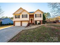 Brick and vinyl two-story house with a two-car garage and landscaped yard at 5241 Whitewater Dr, Hickory, NC 28601