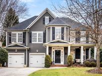 Gray two-story house with black shutters, two-car garage, and manicured lawn at 616 N Oak Dr, Huntersville, NC 28078