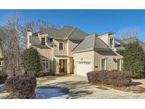 Brick two-story house with a three-car garage and manicured landscaping at 6926 Linkside Ct, Charlotte, NC 28277