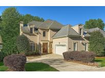 Charming two-story home featuring a well-manicured lawn, brick exterior, and attached two-car garage at 6926 Linkside Ct, Charlotte, NC 28277