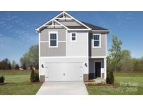 Two-story home with gray siding, white garage door, and landscaping at 821 Blue Canyon Dr, York, SC 29745