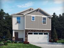 Two-story home with gray siding, stone accents, and a two-car garage at 821 Blue Canyon Dr, York, SC 29745