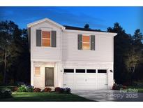 Two-story house with white siding, a two-car garage, and landscaping at 853 Blue Canyon Dr, York, SC 29745