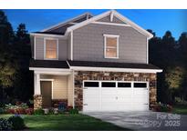 Two-story home with stone accents and a two-car garage at 909 Smithcliffs Trl, York, SC 29745