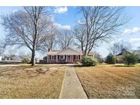 Brick ranch home with walkway, mature trees, and a well-maintained lawn at 2203 O'Hara Dr, Charlotte, NC 28273