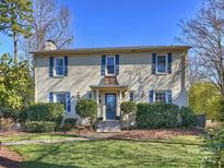 Brick home with blue shutters, landscaping, and a welcoming front porch at 2625 Croydon Rd, Charlotte, NC 28209