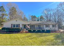 Charming ranch home with white brick exterior, landscaping, and a spacious yard at 3720 Fairlane Dr, Gastonia, NC 28056