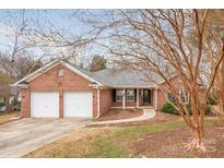 Brick ranch home with two-car garage and landscaped yard at 3903 Bon Rea Dr, Charlotte, NC 28226