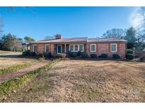 Brick ranch house with a landscaped yard and walkway at 401 Kenwood Ave, Cherryville, NC 28021