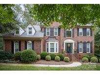 Brick two-story house with black shutters, landscaping, and a walkway at 8804 Ferngrove Ct, Waxhaw, NC 28173