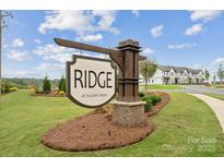 Ridge at Sugar Creek community entrance sign with townhomes in background at 1182 Lost Cove Rd, Indian Land, SC 29707