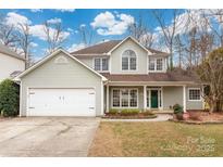 Charming two-story home with a two-car garage, lush landscaping, and inviting curb appeal at 17521 Cambridge Grove Dr, Huntersville, NC 28078