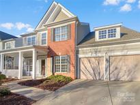 Two-story brick home with a large front porch and attached two-car garage at 18414 Victoria Bay Dr, Cornelius, NC 28031