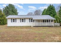 Charming single-story home with a metal roof and inviting front porch at 1876 Rollins Dr, Catawba, NC 28609