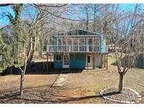 Quaint lakefront cottage with elevated deck and surrounding trees at 198 Clouse Ln, Taylorsville, NC 28681