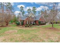 Brick house with a landscaped yard and a walkway leading to the front door at 2044 Chameleon Rd, York, SC 29745