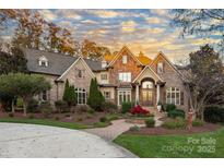 Stunning brick home with manicured landscaping, mature trees, and inviting curb appeal at 2907 Cutter Ct, Waxhaw, NC 28173