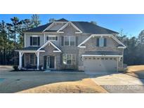 Beautiful two-story home featuring stone accents, a two-car garage, and well-maintained landscaping at 5057 Spratt Rd, York, SC 29745