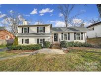 Charming ranch home with white exterior, black shutters, and manicured lawn at 6737 Lancer Dr, Charlotte, NC 28226