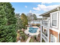 Community pool with lake views and surrounding deck at 7844 Village Harbor Dr # 36, Cornelius, NC 28031