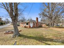 Charming brick home featuring a brick chimney and mature trees in a peaceful neighborhood at 901 Maple Ave, Salisbury, NC 28144