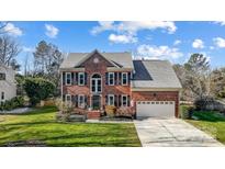 Brick two-story house with a large yard and attached garage at 9236 Silver Pine Dr, Charlotte, NC 28277