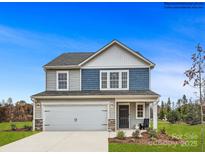 Two-story home with gray and blue siding, two-car garage, and landscaping at 117 Mountain Bridge Way, Statesville, NC 28625