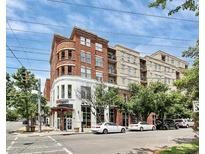 Beautiful exterior of brick building with arched corner design, street view, and visible commercial space on the ground floor at 1315 East Blvd # 203, Charlotte, NC 28203