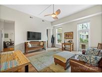 Spacious living room with hardwood floors and access to a balcony at 1315 East Blvd # 203, Charlotte, NC 28203