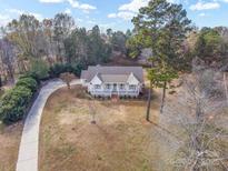 Aerial view of a charming ranch house with a large front yard and long driveway at 160 Pampas Ln, Mooresville, NC 28117