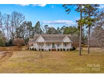 Charming one-story home with a front porch and landscaped yard at 160 Pampas Ln, Mooresville, NC 28117