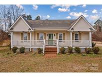 House with a large front porch and landscaping at 160 Pampas Ln, Mooresville, NC 28117