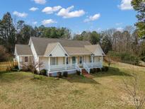 Charming single-story home with a welcoming front porch and manicured landscaping at 160 Pampas Ln, Mooresville, NC 28117