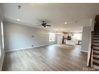 Bright, open-concept living space with modern flooring and a ceiling fan at 266 Gilead Rd, Huntersville, NC 28078