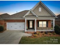 Brick ranch home with a two-car garage and landscaped front yard at 2836 Santiago Cir, Monroe, NC 28110