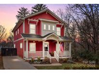 Beautiful two-story red house with a front porch and landscaped yard at 423 Solomon St, Charlotte, NC 28216