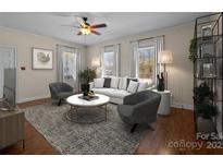 Bright living room features hardwood floors, comfy seating, and large windows at 535 5Th St, Chester, SC 29706