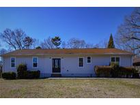 Charming single-story home with a well-maintained lawn and mature landscaping at 6615 Love Mill Rd, Monroe, NC 28110