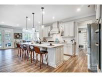 Open concept kitchen with large island and hardwood floors at 9428 Liberty Hill Dr, Mint Hill, NC 28227