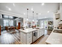 Open kitchen with a large island, modern appliances, and hardwood floors, creating a perfect space for cooking at 9428 Liberty Hill Dr, Mint Hill, NC 28227