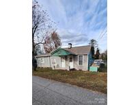 Charming single-story house with a teal exterior, covered porch, and spacious yard at 3706 2Nd Nw Ave, Hickory, NC 28601
