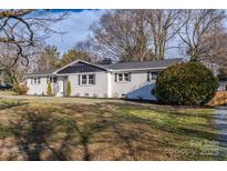Charming single-story home with painted brick, black shutters, and mature landscaping at 6305 Dale Ave, Charlotte, NC 28212