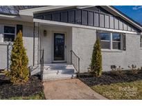 Inviting front entrance with fresh paint and a landscaped walkway, creating a warm and welcoming curb appeal at 6305 Dale Ave, Charlotte, NC 28212