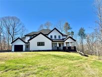 Stunning new construction home with black trim, bright white siding, and a covered porch at 177 Olympia Dr, Mooresville, NC 28117