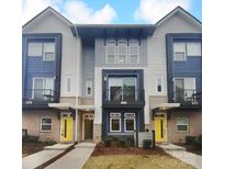 Modern three-story townhome with yellow door and gray siding at 2124 Electric Ln, Charlotte, NC 28205