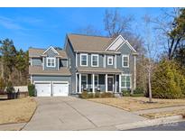 Two-story house with gray siding, a two-car garage, and a landscaped front yard at 857 Spelman Dr, Indian Land, SC 29707