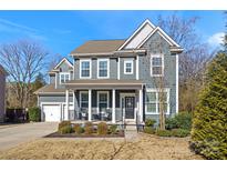 Two-story house with gray siding, a front porch, and a landscaped yard at 857 Spelman Dr, Indian Land, SC 29707