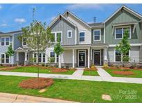 Charming new townhomes with stone accents, well-manicured lawns, and inviting front porches at 10117 Mamillion Dr, Huntersville, NC 28078