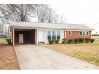 Charming single-story brick house with a carport and a well-maintained front yard at 1715 Emmanuel Church Rd, Conover, NC 28613